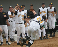 Shea Roehrkasse makes an off-balance play in front of the Gustavus dugout.