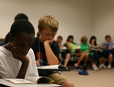 Gustavus NYSP students read books that were donated.