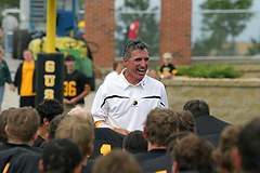 Head Coach Jay Schoenebeck celebrates with his squad after the game.