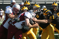 The Gustie defense gang tackles a Piper running back.