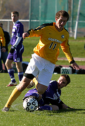 Fraser Horton keeps the ball away from a sliding St. Thomas defender.