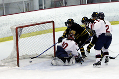 Gustavus players crashed the net against Saint Mary's.