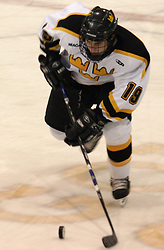 Brad Wieck controls the puck at center ice.