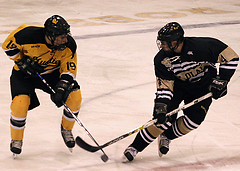 The Gusties Brad Wieck (#19) battles the Oles David Adams (#4) for control of the puck at center ice.