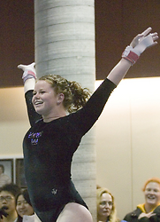 Junior Christine Askham celebrates after a strong bar routine.