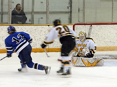 Goaltender Josh Swartout makes a save against Marian.