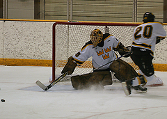 Goaltender Matt Lopes registers a kick save.