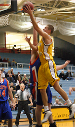 Trevor Wittwer goes up high to score with his left hand in the first game against Macalester.