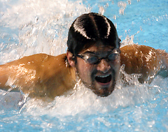 Swimmer pushes himself towards the wall.