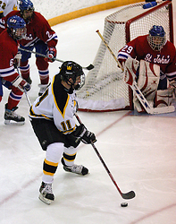 David Martinson looks to pass in front of the Saint John's net.