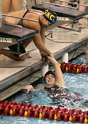 Jonna Berry is congratulated after swimming the anchor leg of a relay.  (Photo Courtesy of Ryan Coleman, d3sports.com)