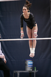 Kelly Mathewson performs on the uneven parallel bars.