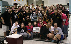 Both squads with their MIAC Championship trophies.  (Photo Courtesy Ryan Coleman, d3sports.com)