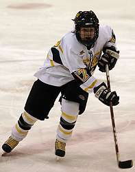 Christine Wicker moves the puck up ice.