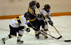 Christine Wicker and Jessica Doig battle for positioning to get to the puck.
