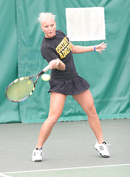 Sam Frank drives a forehand across the net.