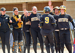 Rachael Click being congratulated after her three-run home run. (Photo: Saint Mary's Sports Information)