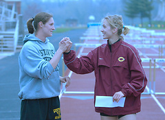 Lundstrum (left) shown shaking hands with first place finisher Leah Kay of Concordia. (photo by Dave Pape)