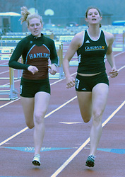 Lundstrum (right) shown racing to the finish of the 800 meters with Emily Amici of Hamline. (Photo by Dave Pape)
