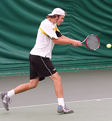 Nick Hansen rips a backhand in his doubles match.