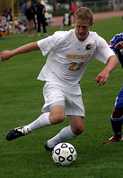 Sophomore midfielder Dan Jarrett works to beat a Tiger defender near the end line.