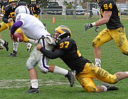 Defensive end Jerry Millan sacks St. Thomas quarterback Ryan Jansen.
