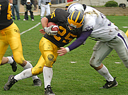 Running back Mitch Anderson lowers his shoulder for some tough yards against a Tommy defender.