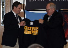 Athletics Director Al Molde presenting a Gustavus sweatshirt to Haugen.