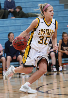 Senior guard Emily Nelson with pink shoelaces and head band last year against Carleton.