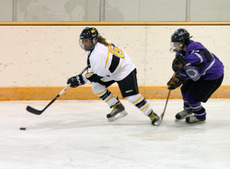 Whitney Schaff keeps the puck from a Tommie defender in the Gusties 1-0 win over St. Thomas earlier this season.