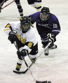 Whitney Schaff works to skate past a St. Thomas defender.