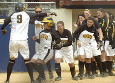 Andrea Brown steps on home plate after hitting a three-run home run in the sixth inning.