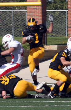 Cody Sukalski jumps through a hole on a kick return.