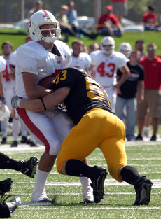 Linebacker Paul Stommes puts a big hit on Johnnie QB Joe Boyle.