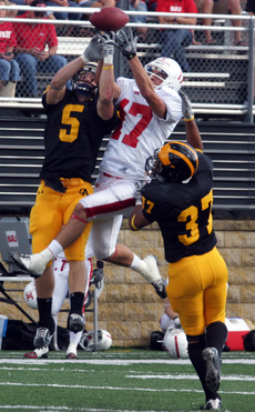 Brad Kruckeburg and Hamada Omar break up a pass intended for Sam Pederson.