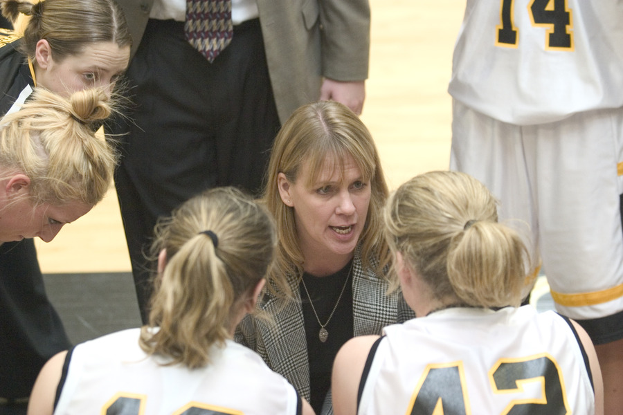 Coach Mickey Haller gives her team direction in the huddle