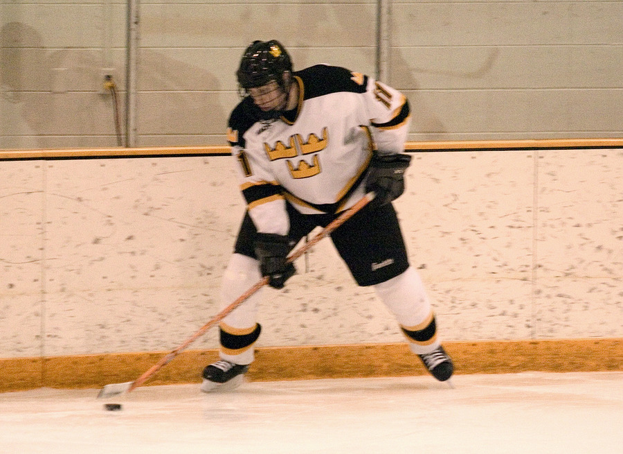 Eric Lindquist handles the puck near the boards.