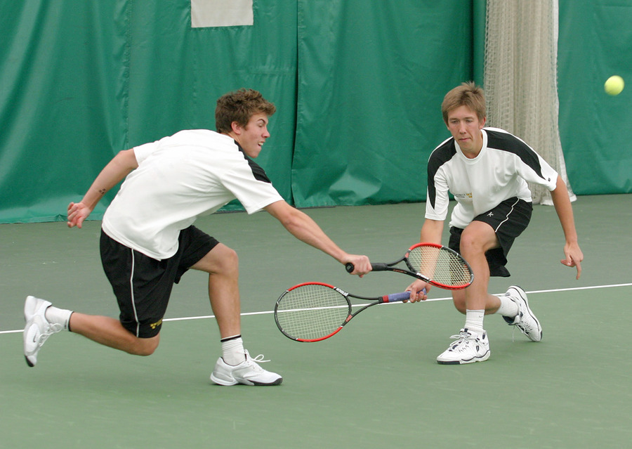 Andy (left) and Roy Bryan return a volley in the #3 doubles match.