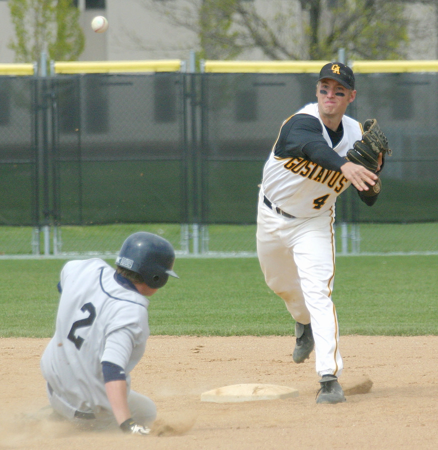 Second baseman Travis Gunderson fires to first to complete a double play.