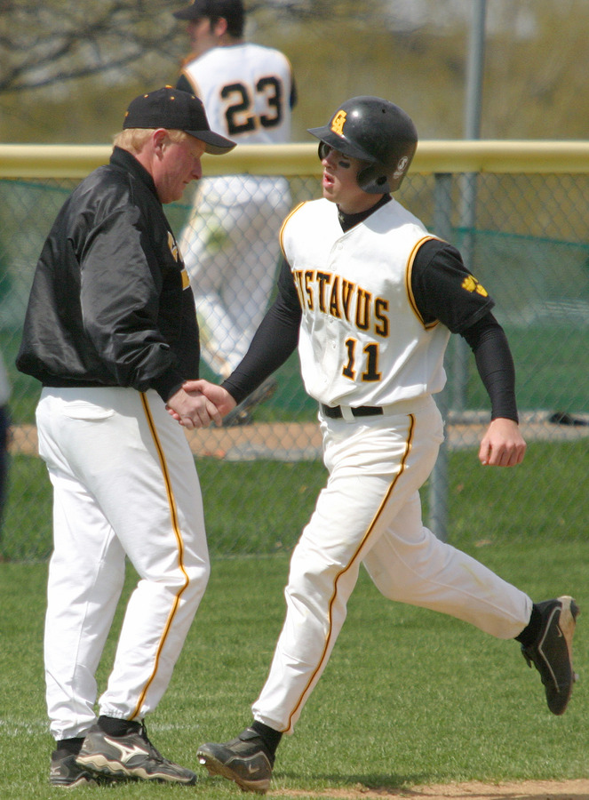 Wade Vrieze is congratulated by Coach Carroll after hitting a two-run home run in game one.
