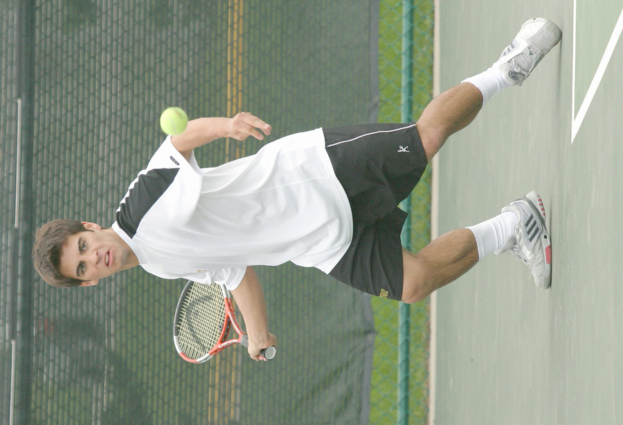Danny Suchy returns a forehand in his doubles match.
