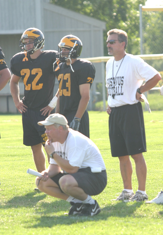 Head Coach Jay Schoenebeck and offensive line coach Gregg Roberts observe practice.