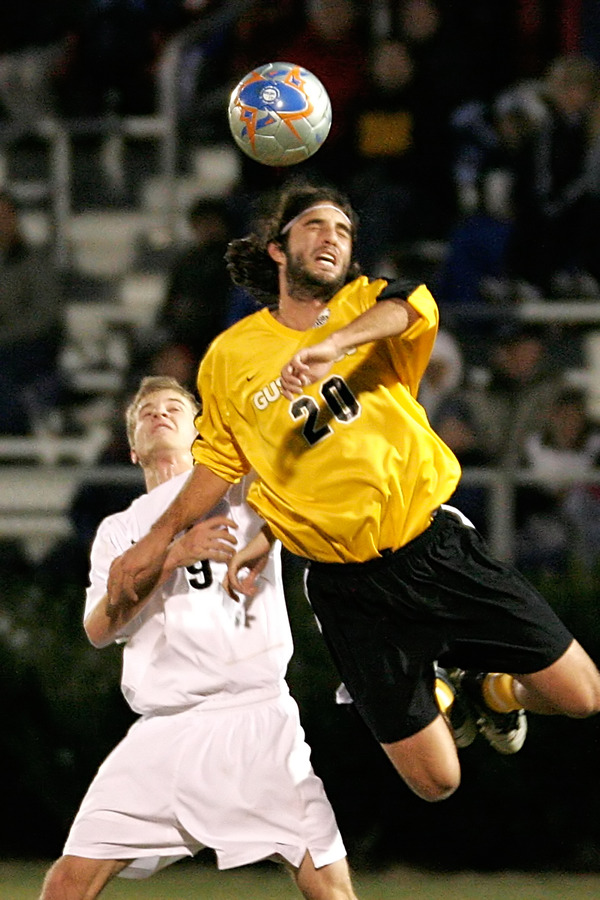 Senior Jon Astry leaps past a Messiah defender to play the ball.