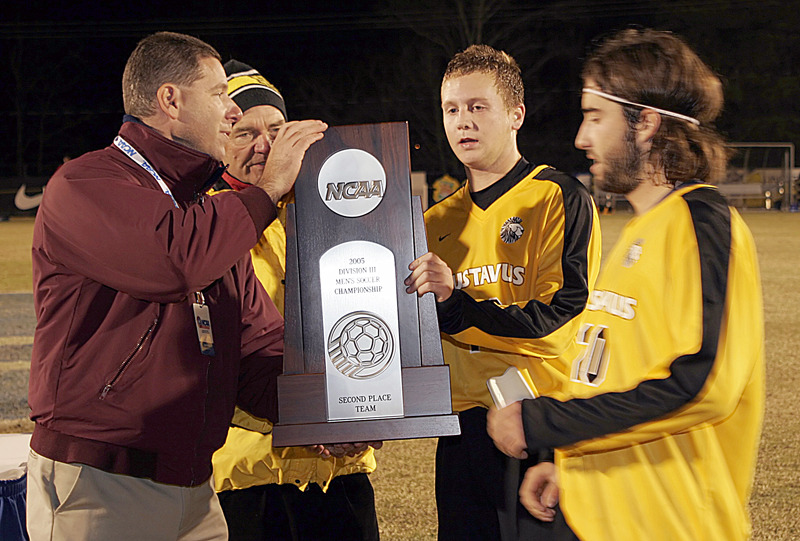 Men’s soccer team accepting second place NCAA trophy last November.