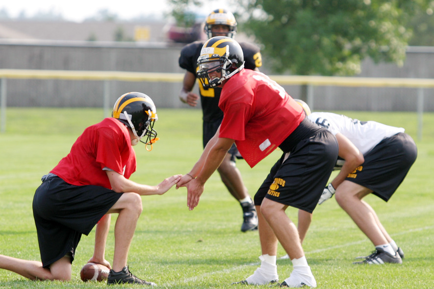 Junior quarterback Jordan Stolp takes the snap during a drill.