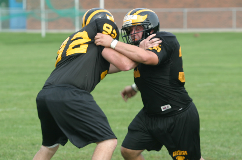 Senior Kory Wermerskirchen (right) rips past senior Greg Carlson during a defensive lineman drill.