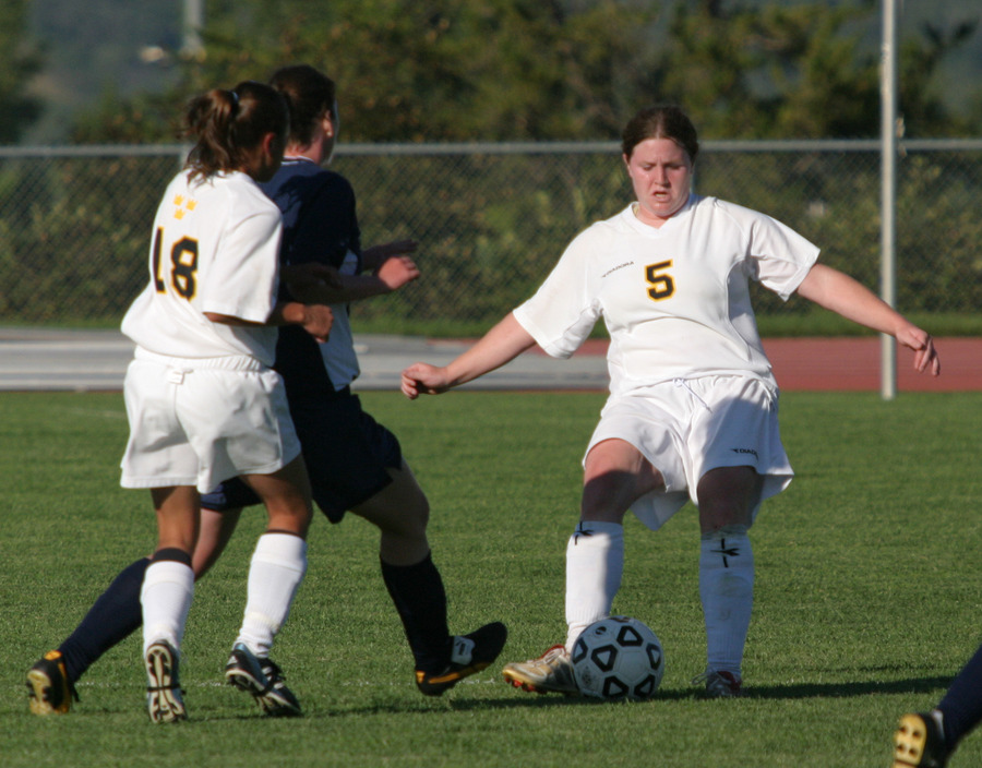 Senior Shannon Quealy (right) fights through a tackle.