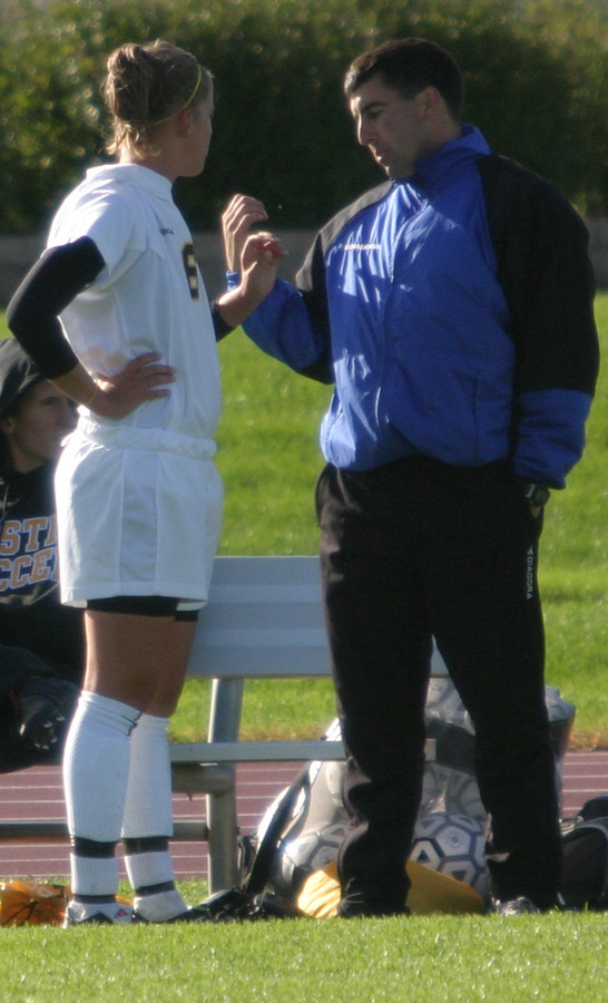 Coach Mike Stehlik instructs senior Amy Larson during a game last season.  Larson led the team with 11 points.