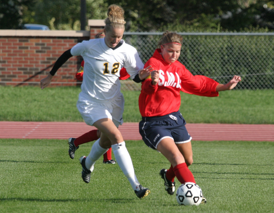 Senior Liz Peterson battles a Saint Mary’s defender for the ball.