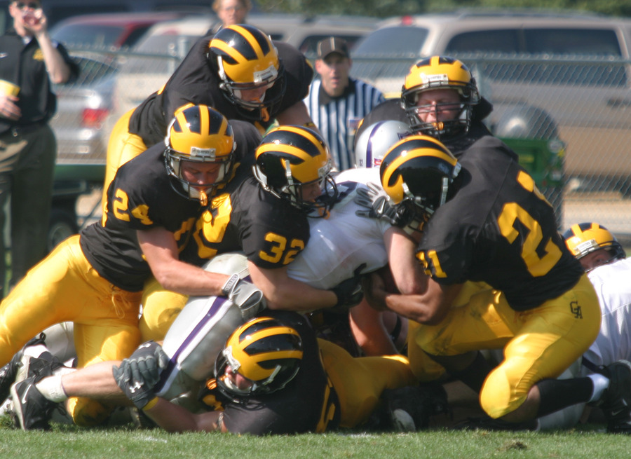 The Gustie defense makes a gang-tackle.